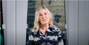 Blonde woman speaking to camera