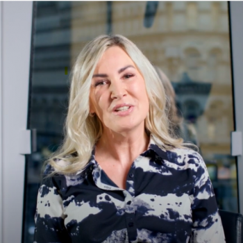 Blonde woman speaking to camera